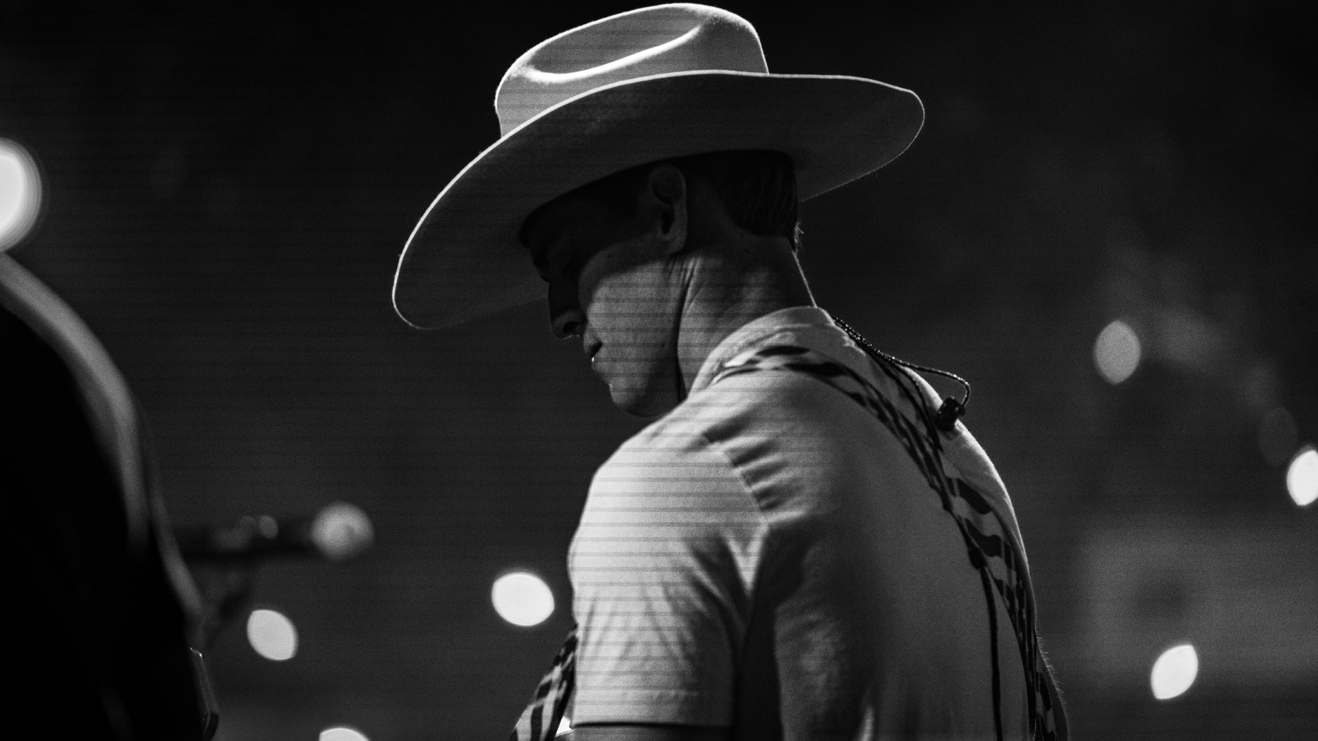 Black and white photograph of Michael Patrick Joyce in a cowboy hat looking down