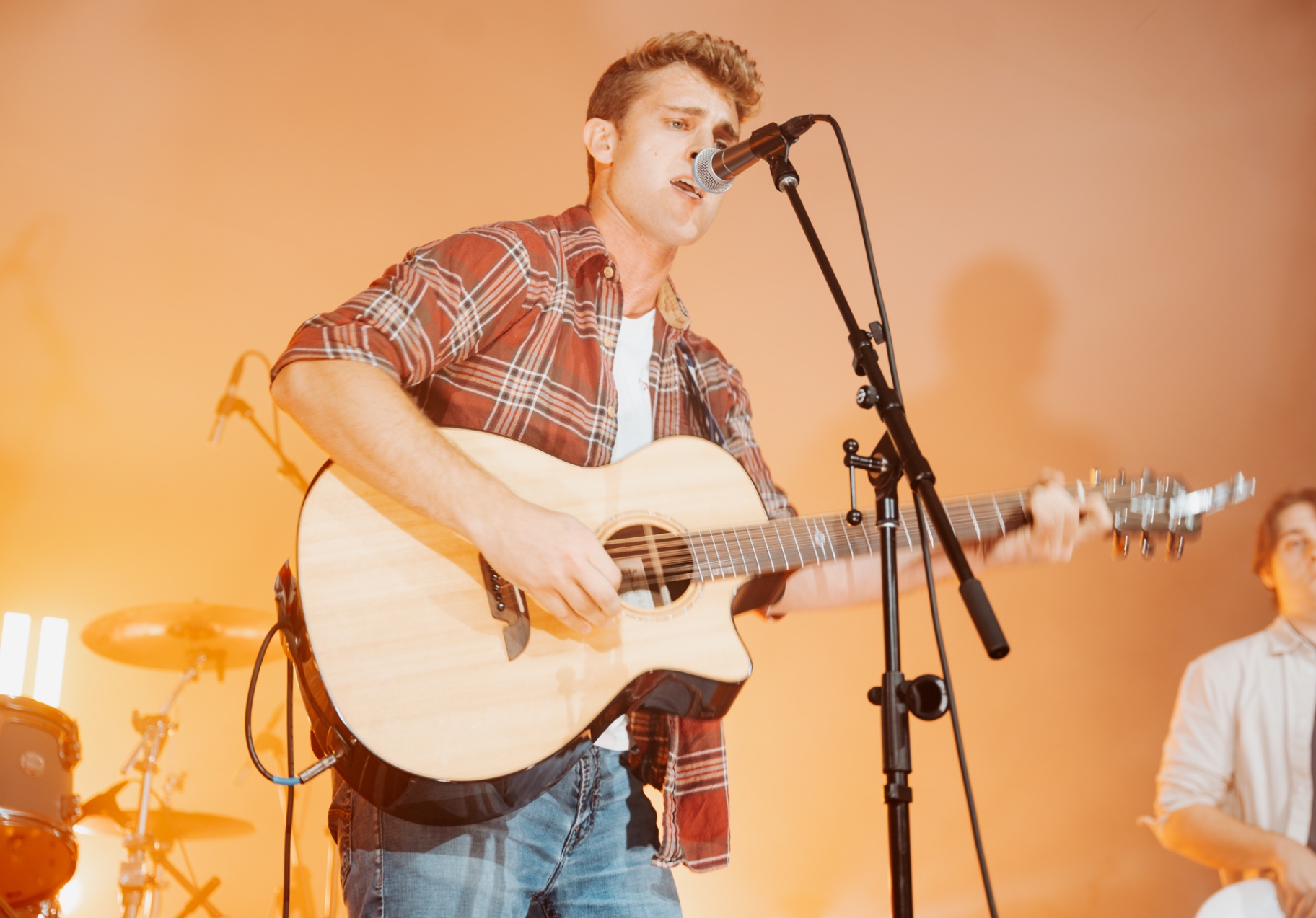 Michael Patrick Joyce performing with his band in warm amber light